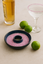Load image into Gallery viewer, Handmade blue ceramic cocktail salt rimmer filled with pink beautyberry salt, surrounded by limes and a glass of tequila