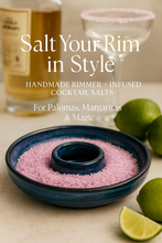 Load image into Gallery viewer, Blue ceramic rimmer filled with pink cocktail salt, shown with limes and a cocktail glass, overlaid text reads “Salt Your Rim in Style – Handmade Rimmer + Infused Cocktail Salts – For Palomas, Margaritas & Magic”