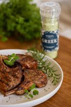 Load image into Gallery viewer, Grilled lamb chops on a ceramic plate with fresh herbs, with a Summa Salts Greek Herb Salt grinder in the background