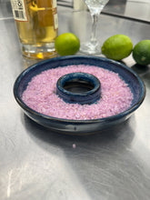 Load image into Gallery viewer, Close-up of a hand-thrown ceramic salt rimmer dish filled with pink salt, with fresh limes and a margarita glass in the background