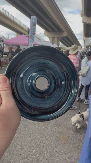 Hand-thrown ceramic cocktail rimmer dish held at a local market, showing handmade glaze and center well